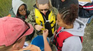 HANDS ON LEARNING Students from Nandua High School inspect a fiddler crab during an experiential field trip to Parramore Island. © TNC